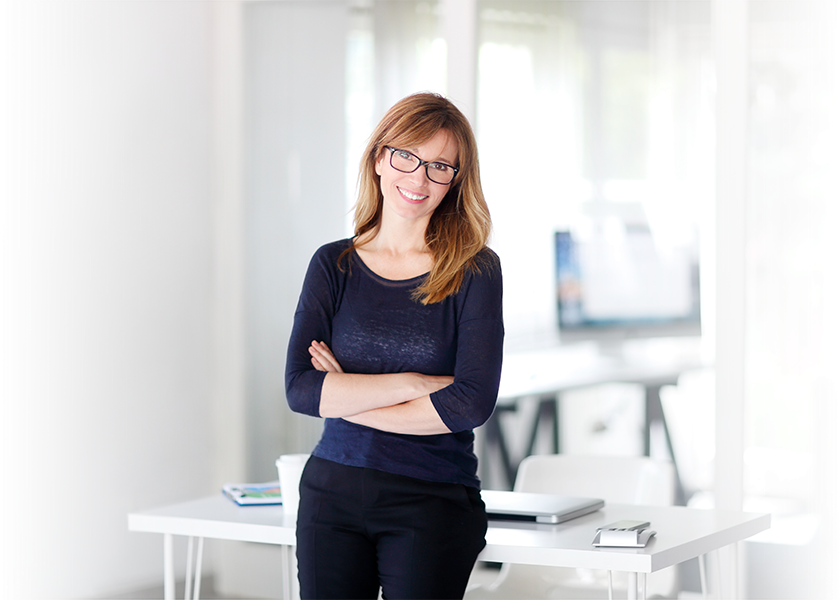 Smiling woman in front of desk